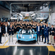 A photo of Lamborghini workers next to the last Aventador